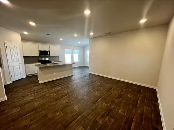 a kitchen with granite countertop a stove and a refrigerator
