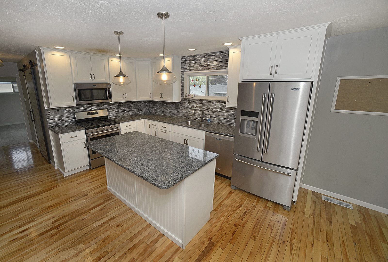 1100 4-H Road Ottawa, IL 61350 - Photo 5 of 21 a kitchen with stainless steel appliances granite countertop a refrigerator a sink a stove a microwave and wooden floors