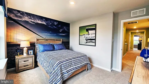 a bedroom with a bed and a view of living room