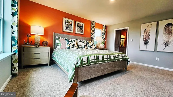 a bedroom with a bed dresser and window