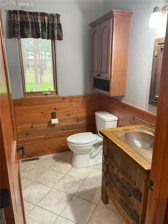 a bathroom with a sink a toilet and mirror
