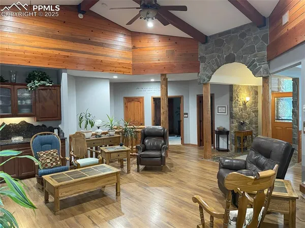 a living room with furniture and a chandelier