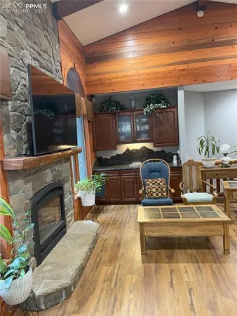 a living room with fireplace furniture and a flat screen tv