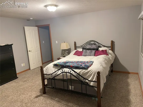 a bedroom with a bed and a mirror