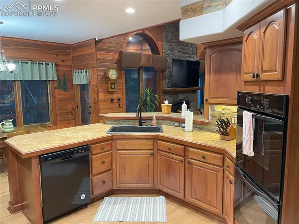 a kitchen with stainless steel appliances granite countertop a sink and a stove