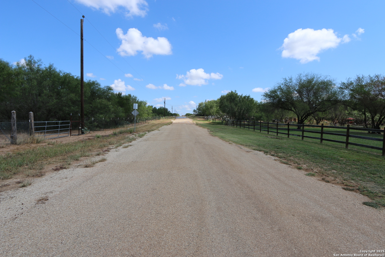 125 County Road 2666 Devine, TX 78016 - Photo 8 of 9 a view of a road with a big yard