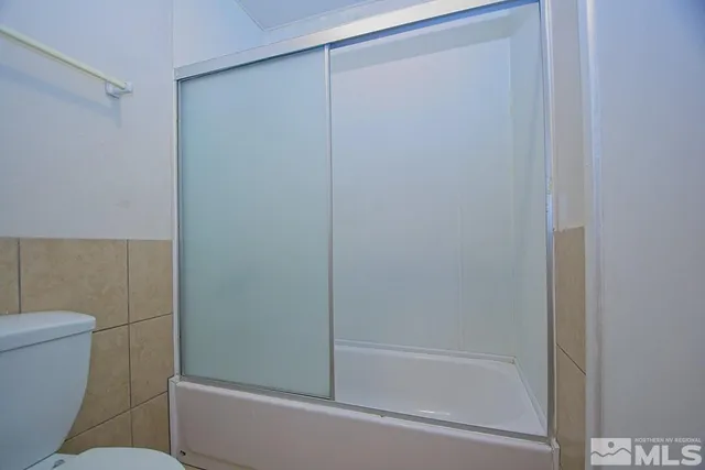 a bathroom with a shower and a toilet