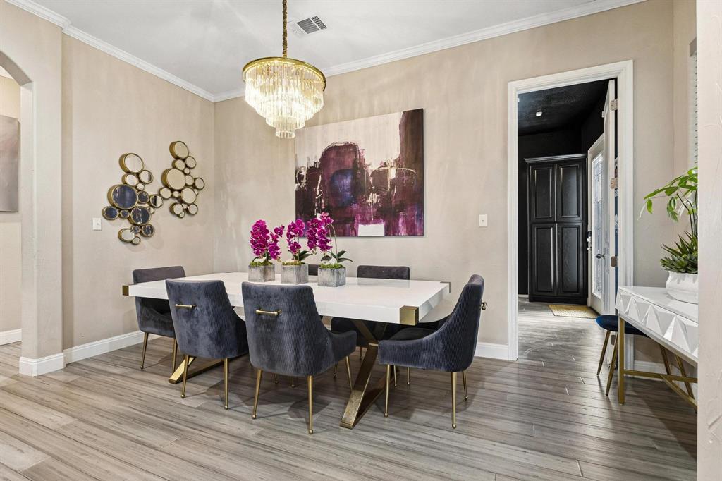 1517 Bennett Road Howe, TX 75459 - Photo 10 of 40 Dining area with light wood-style flooring, hanging lights, arched walkways, and ornamental molding