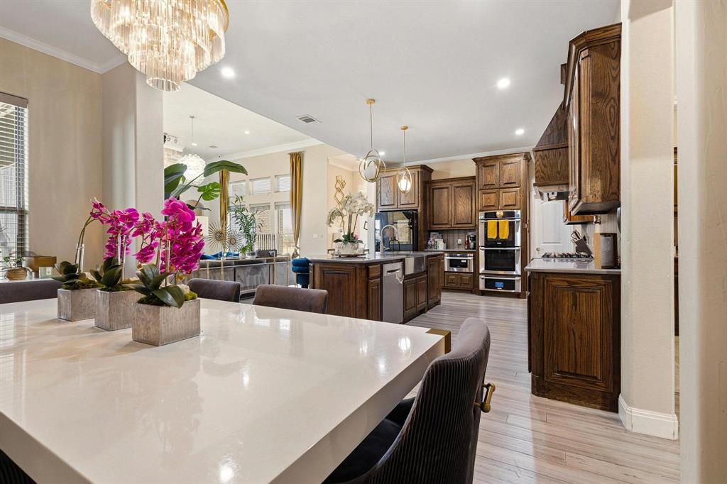 1517 Bennett Road Howe, TX 75459 - Photo 11 of 40 Dining area with ornamental molding, light wood-style floors, and suspended lighting