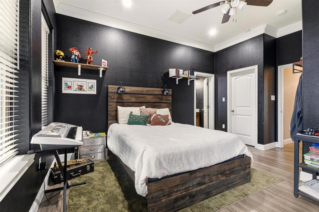 1517 Bennett Road Howe, TX 75459 - Photo 18 of 40 Bedroom featuring wood finished floors, a ceiling fan, and crown molding