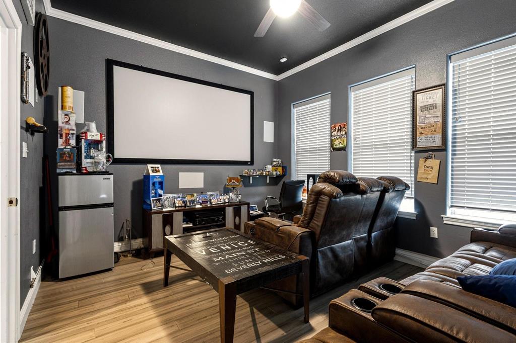 1517 Bennett Road Howe, TX 75459 - Photo 19 of 40 Cinema room featuring ceiling fan, light wood-style flooring, and ornamental molding