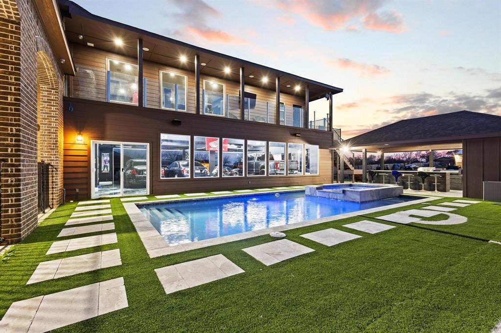 1517 Bennett Road Howe, TX 75459 - Photo 3 of 40 Back of property at dusk featuring a balcony, a yard, a pool with connected hot tub, and a patio area