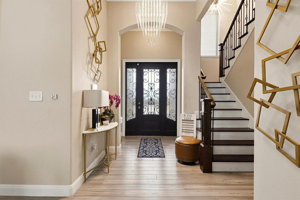 1517 Bennett Road Howe, TX 75459 - Photo 5 of 40 Entrance foyer with light wood-style flooring, arched walkways, a chandelier, and a high ceiling