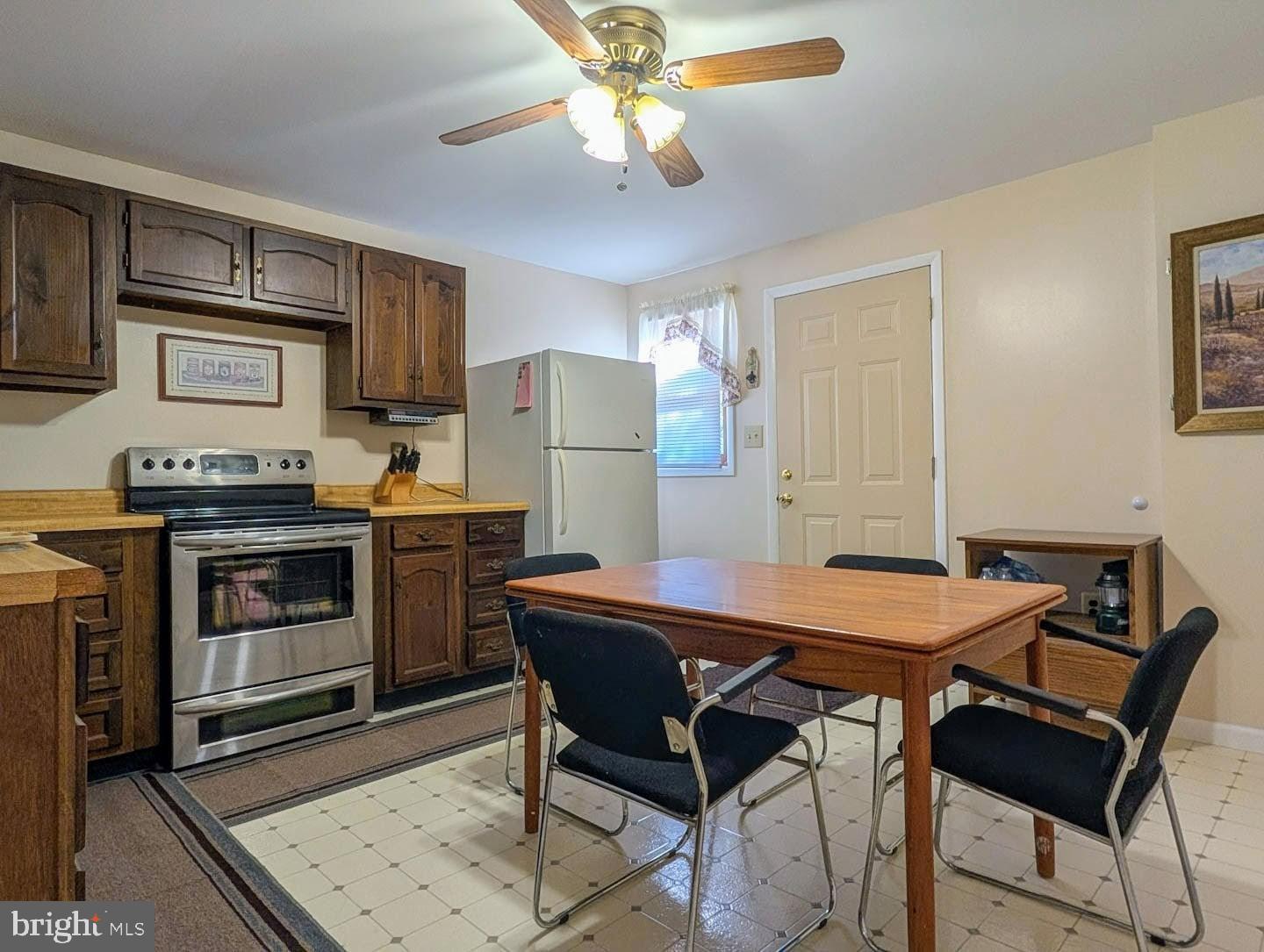 939 Collins Road Artemas, PA 17211 - Photo 11 of 43 a kitchen with a table chairs refrigerator and microwave