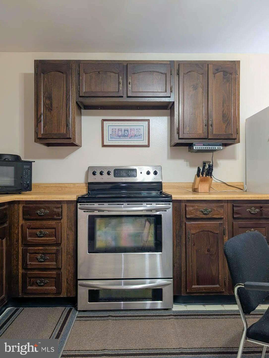 939 Collins Road Artemas, PA 17211 - Photo 13 of 43 a kitchen with granite countertop a stove and a microwave oven