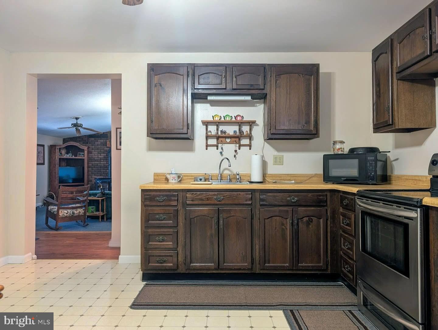 939 Collins Road Artemas, PA 17211 - Photo 14 of 43 a kitchen with stainless steel appliances granite countertop a stove microwave and sink