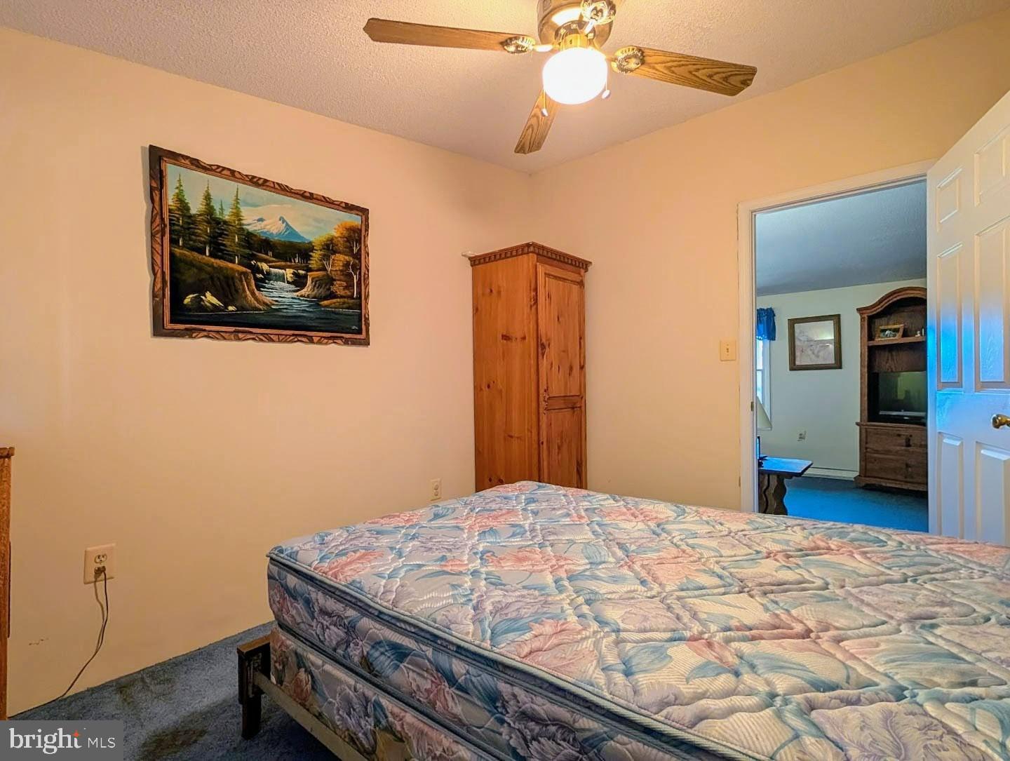 939 Collins Road Artemas, PA 17211 - Photo 7 of 43 a bedroom with a bed and a chandelier