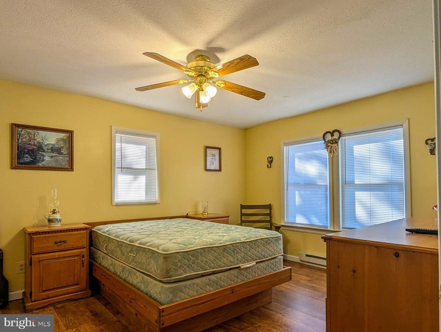 939 Collins Road Artemas, PA 17211 - Photo 9 of 43 a bedroom with a bed and wooden floor