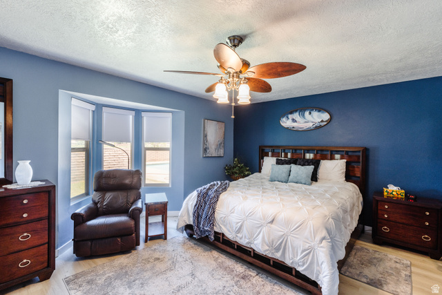 1470 Redwood Tree Street St. George, UT 84790 - Photo 11 of 53 Spacious room featuring a bay window, wood-finish flooring, and a ceiling fan with integrated lighting