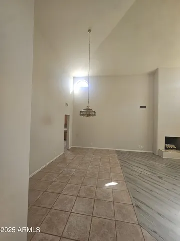 a view of a room with an empty space and a window