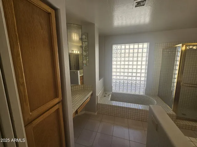 a bathroom with a bathtub and shower