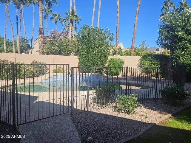 a view of a wrought iron fences in front of house