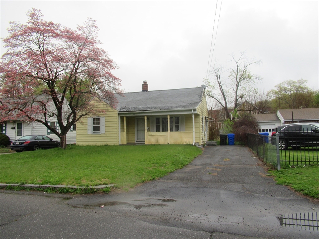 33 Connolly Street Springfield, MA 01151 - Photo 4 of 15 a front view of a house with a garden and trees