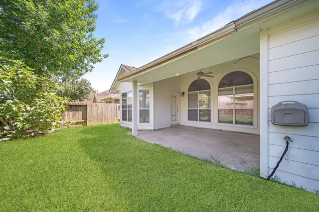 a view of a house with a backyard and a garden