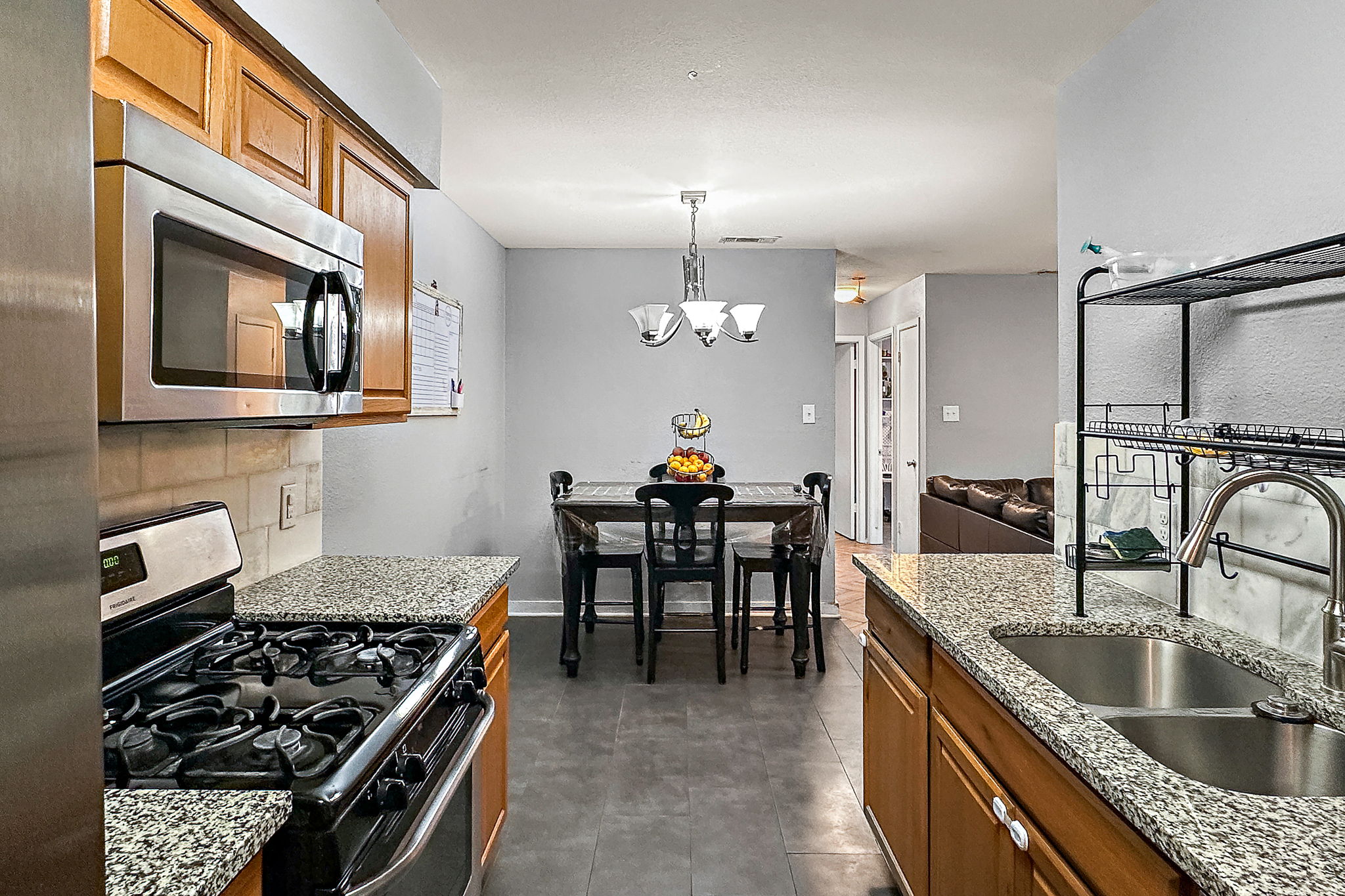 700 Misty Morning Way Round Rock, TX 78664 - Photo 26 of 36 Unit A - A functional kitchen boasts granite counters, stainless steel appliances, and wood cabinetry.