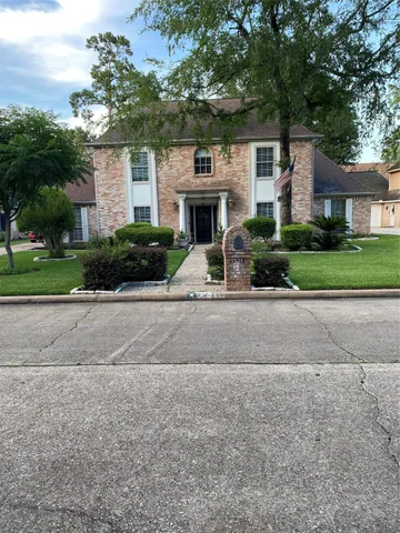 a front view of a house with a yard and a garage