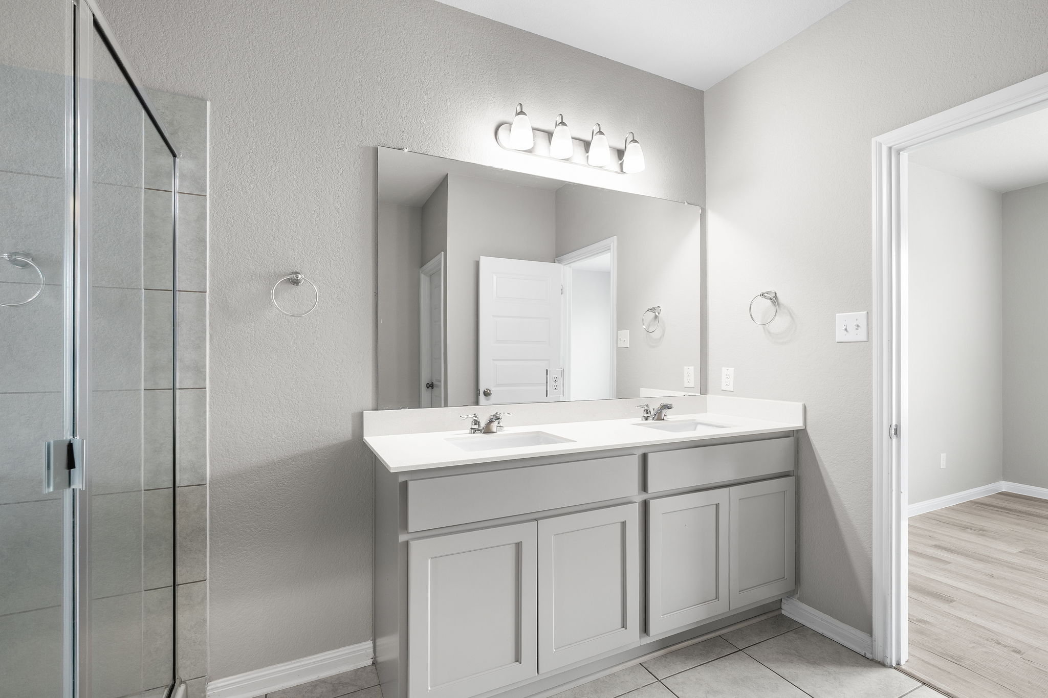 313 Mclintock Road Jarrell, TX 76537 - Photo 26 of 40 A well-appointed bathroom offers a dual vanity, sleek shower, and ample counter space.