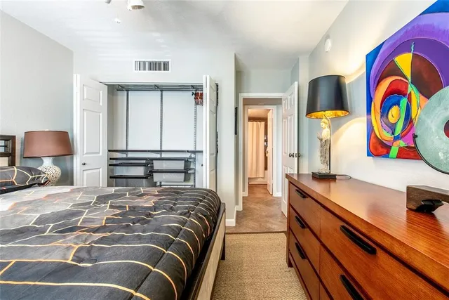 a bedroom with a bed and dresser