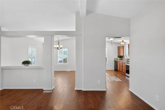 a view of a kitchen with granite countertop stainless steel appliances and a chandelier