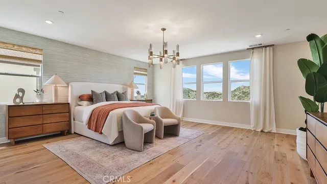 a spacious bedroom with a bed and a window