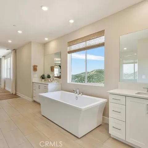 a large white kitchen with a large window