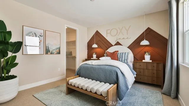 a bedroom with a bed and a potted plant