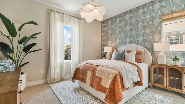 a bedroom with a large bed and a chandelier