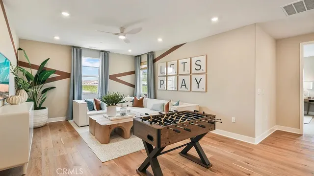 a living room with furniture and a potted plant
