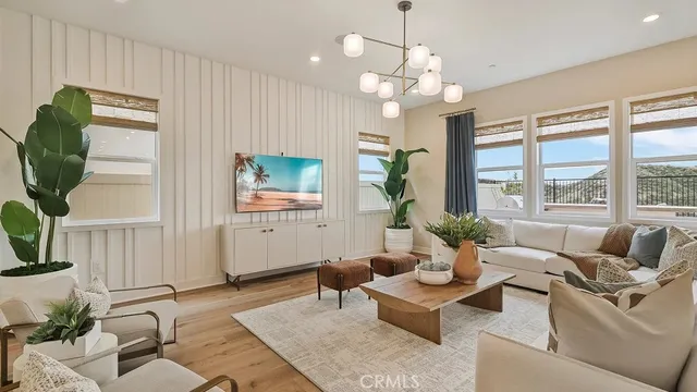 a living room with furniture potted plant and a large window