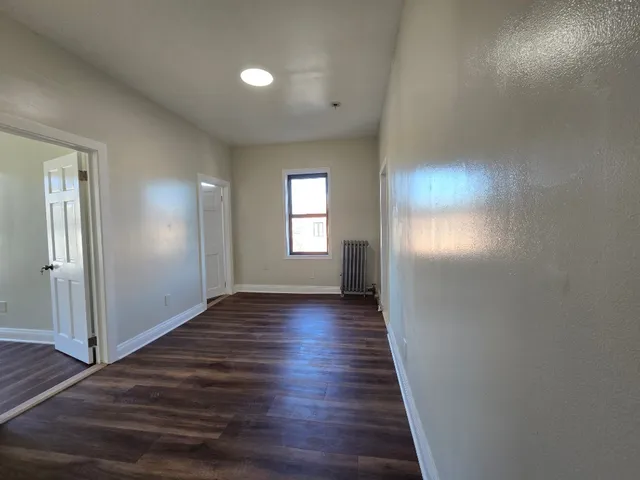 a view of hallway with wooden floor