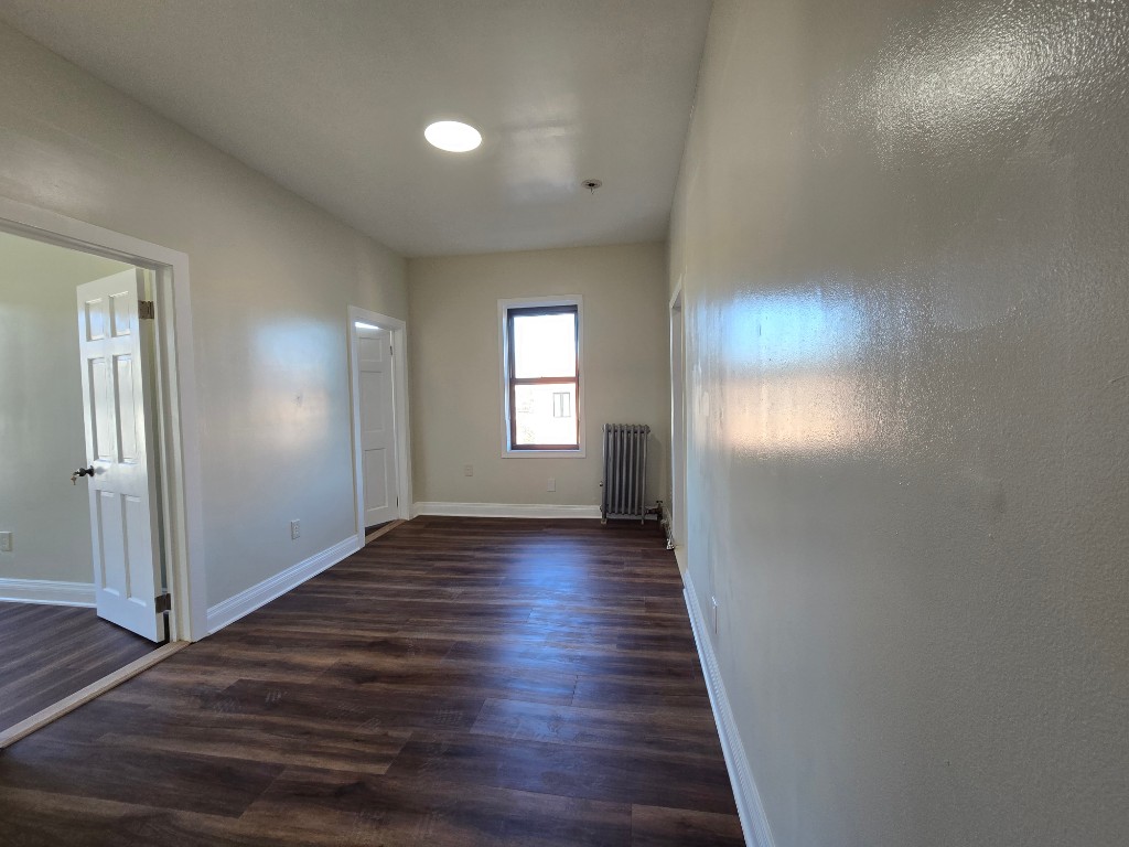 a view of hallway with wooden floor