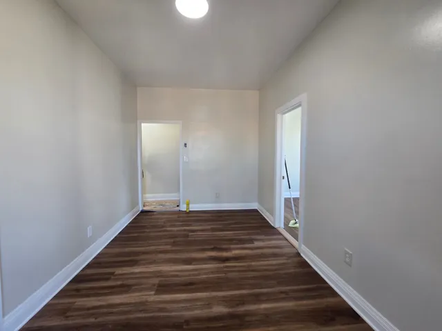 a view of a hallway with wooden floor