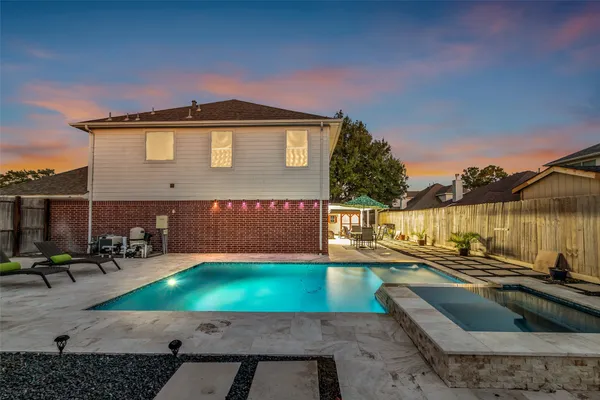 a view of a house with pool and sitting area