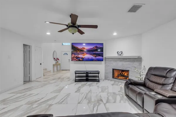 a living room with furniture and a fireplace