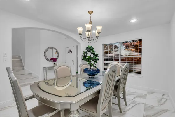 a view of a dining room with furniture and chandelier
