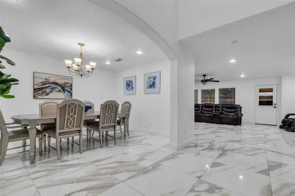 a large kitchen with a table and chairs