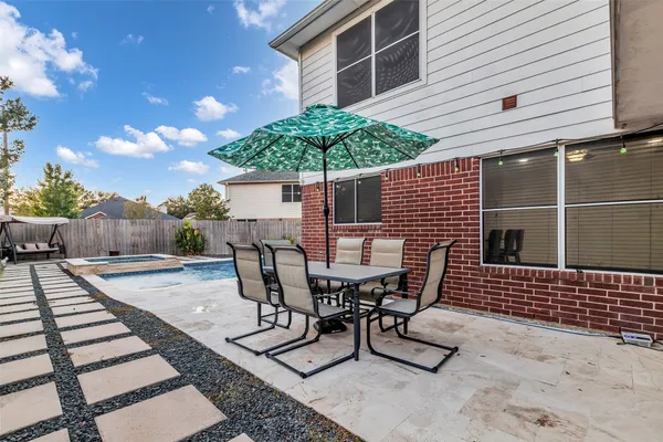 a view of backyard with outdoor seating and plants