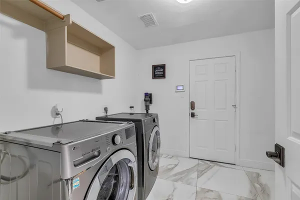a utility room with dryer and washer