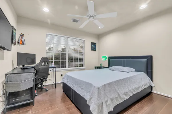 a bedroom with a bed and a desk