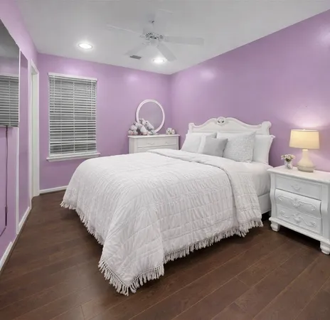 a bedroom with bed and window